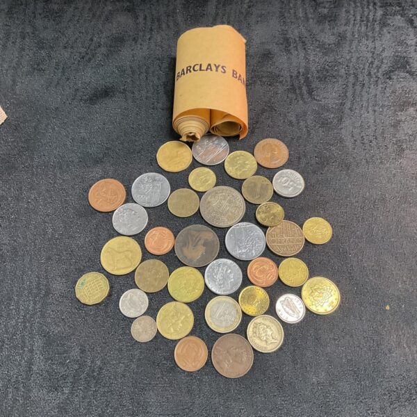 Mixed UK coins in a tub and Barclays Bank rolls.
