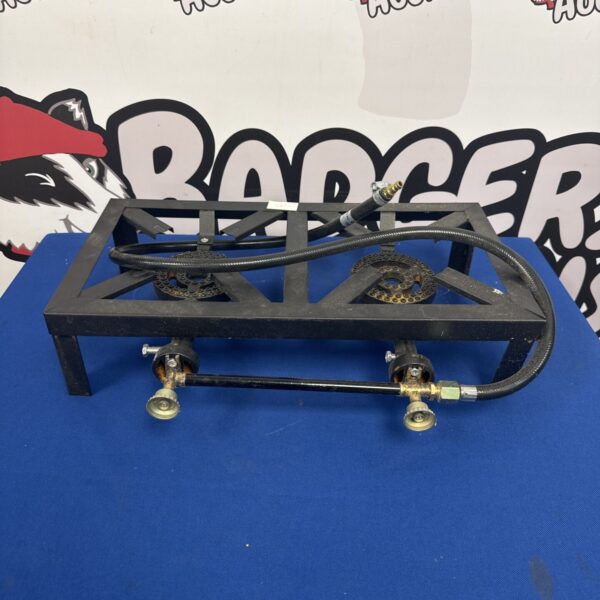 Portable twin burner camping stove for outdoor cooking.