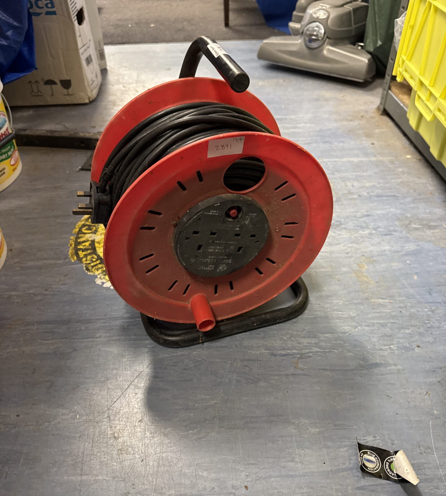 Red two-gang extension reel with cable wound around it.