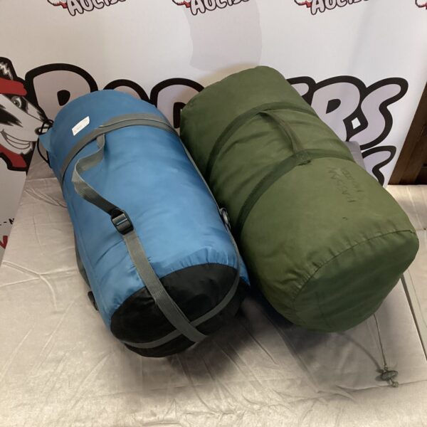 Blue and green roll-top sleeping bags for camping and outdoor use.