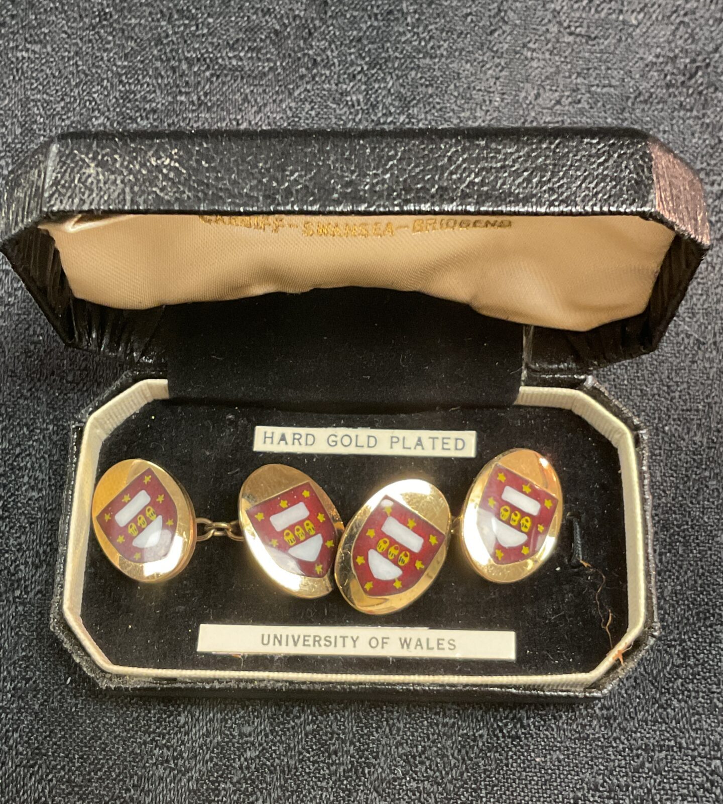 Vintage University of Wales cufflinks with crest detail.