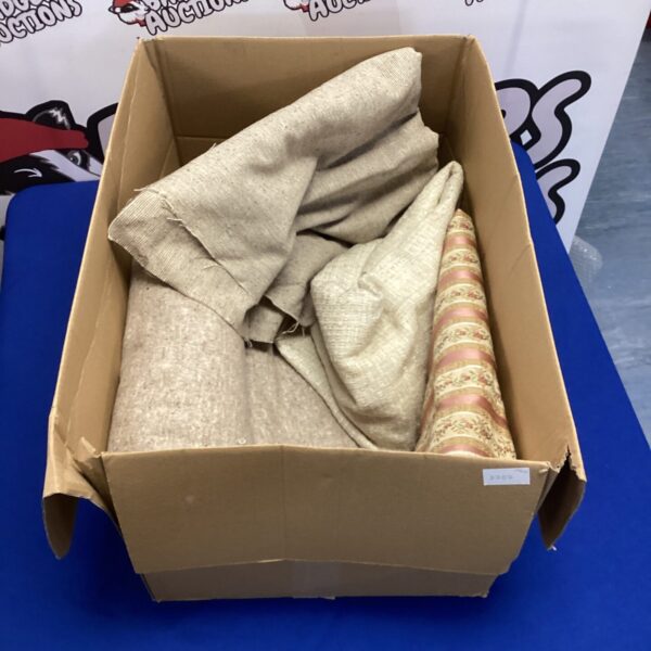 Box of upholstery fabric remnants for crafting projects.