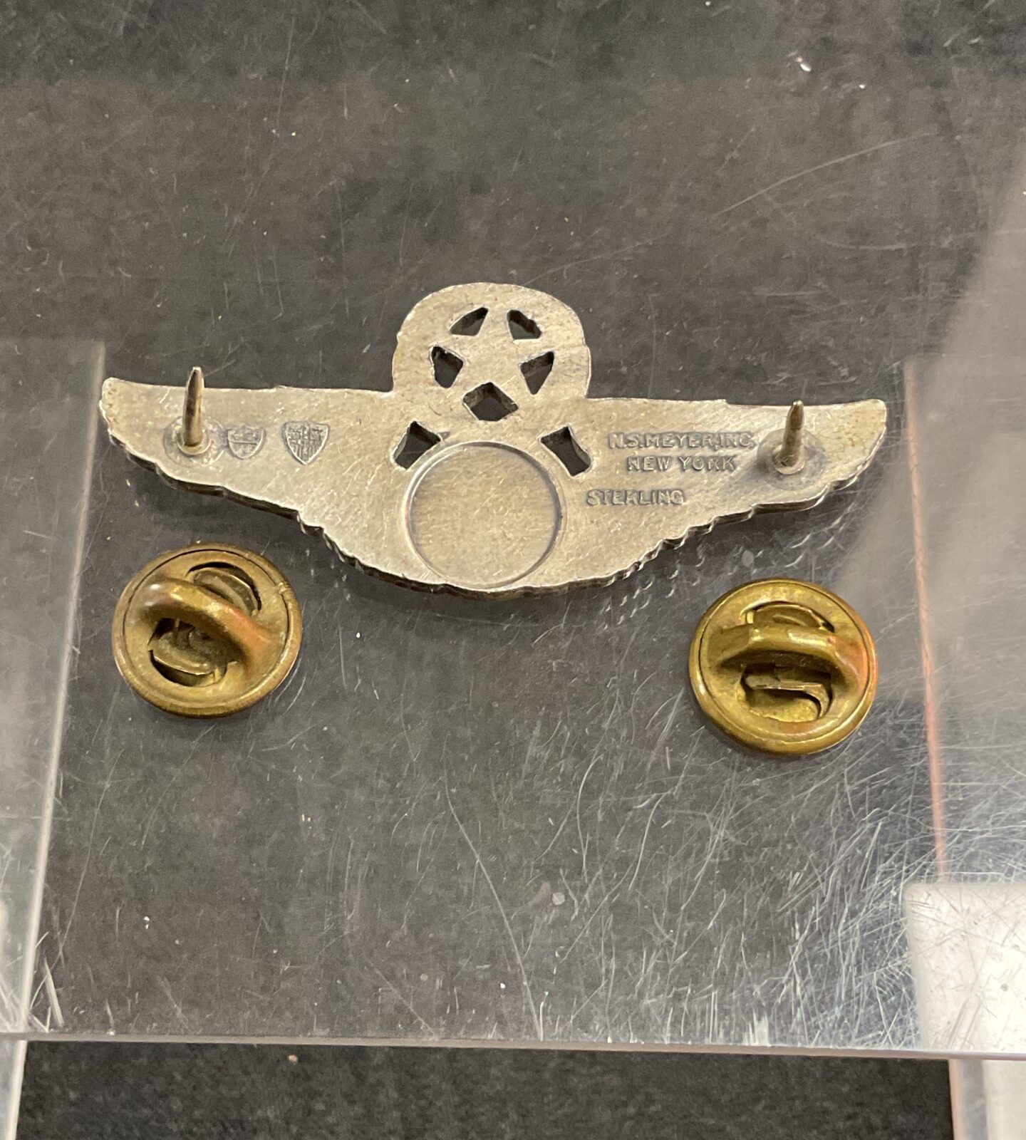 Back view of a vintage USAF Master Aircrew Badge showing the clasp.