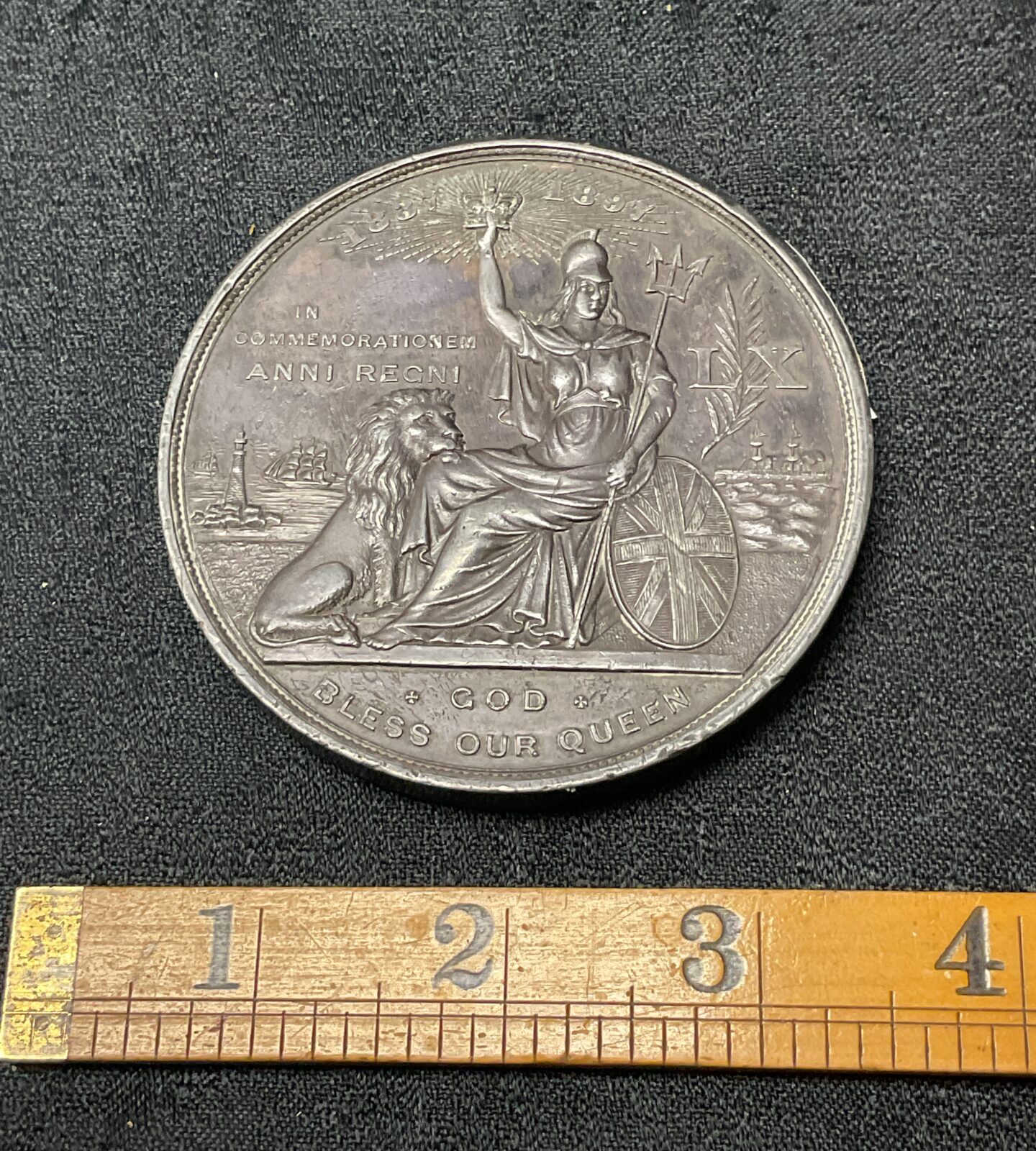 Reverse side of antique Victoria Diamond Jubilee pewter medal.