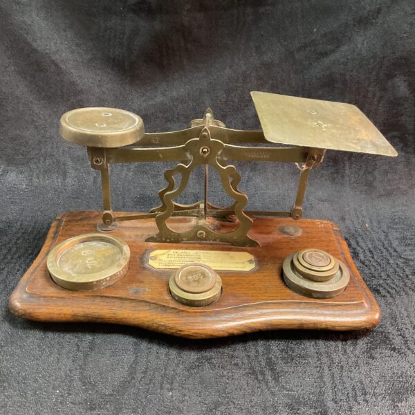 Antique Victorian letter scales with weights on wooden base.
