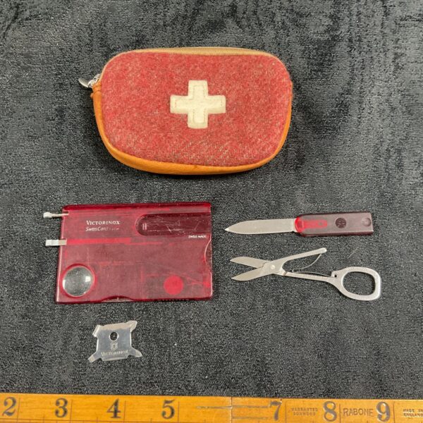 Red handled Victorinox credit card multi tool with case.