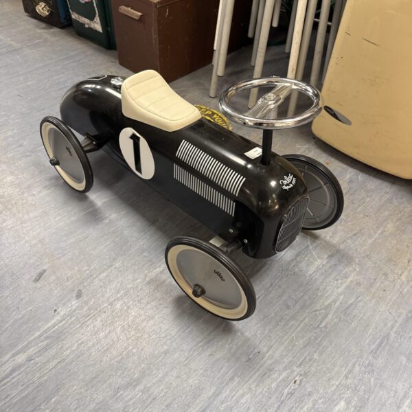Vintage Vilac ride-on car in black with white wheels.