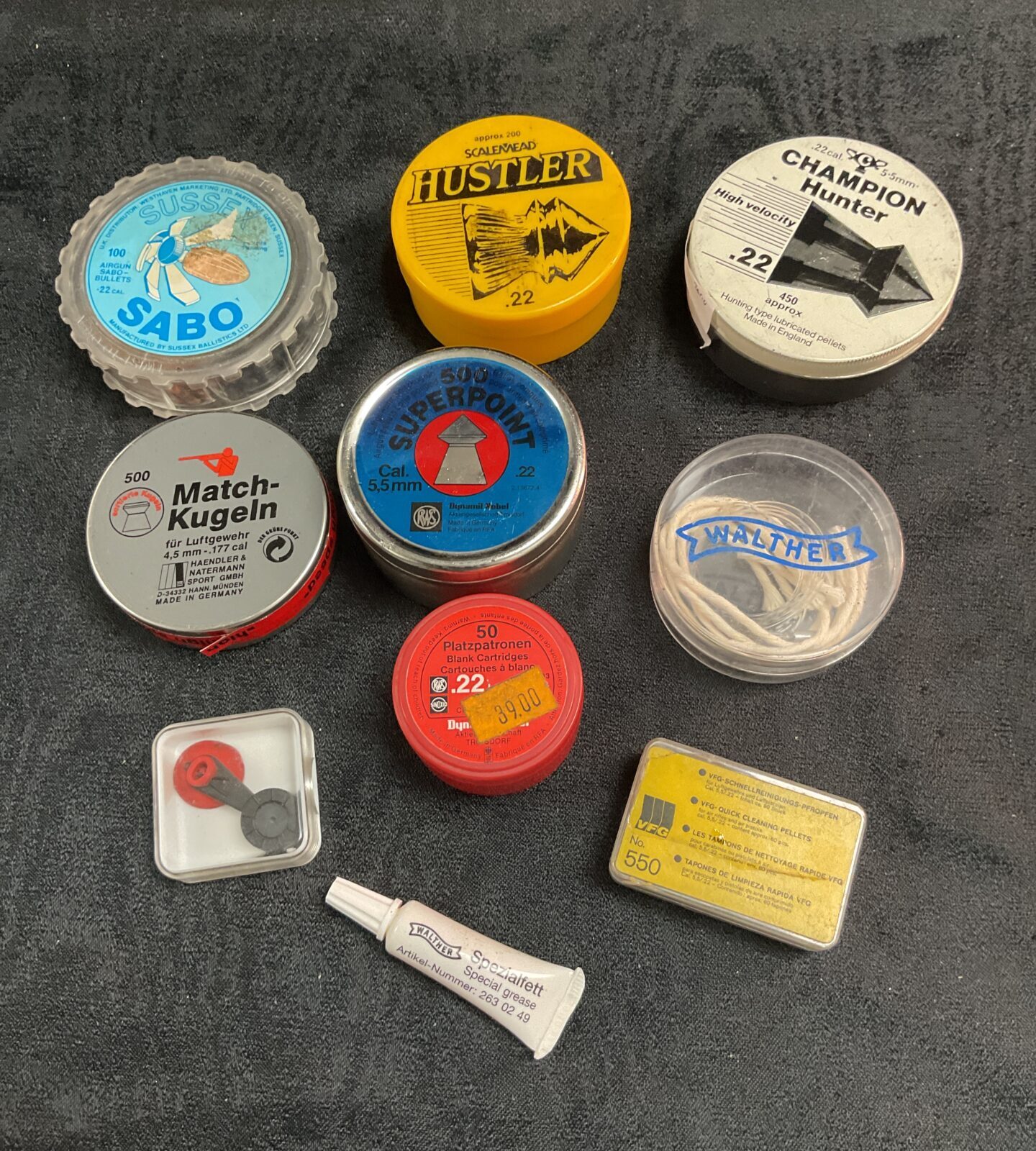 Vintage air rifle pellets in original tins, including Sabo and Hustler brands.