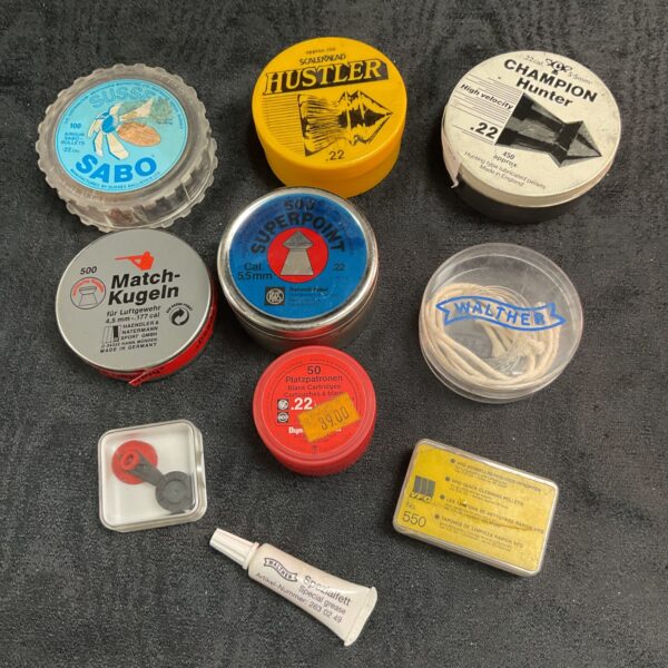 Vintage air rifle pellets in original tins, including Sabo and Hustler brands.