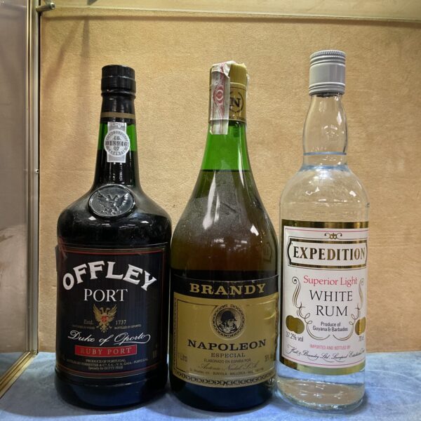 Vintage lot of alcohol bottles including Offley Port and Napoleon Brandy.