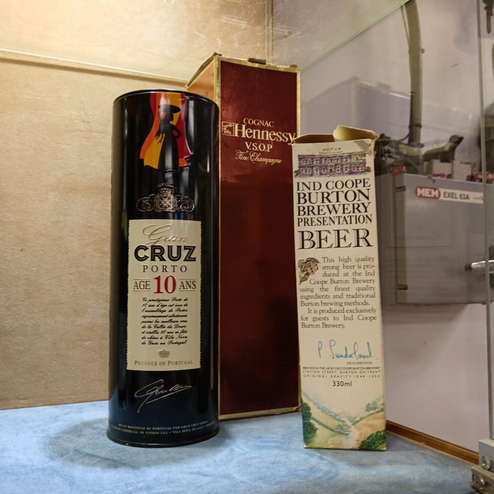 Vintage alcohol lot featuring Hennessy, Gran Cruz, and Burton Brewery bottles.