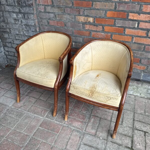 Pair of vintage Art Deco club chairs needing restoration.