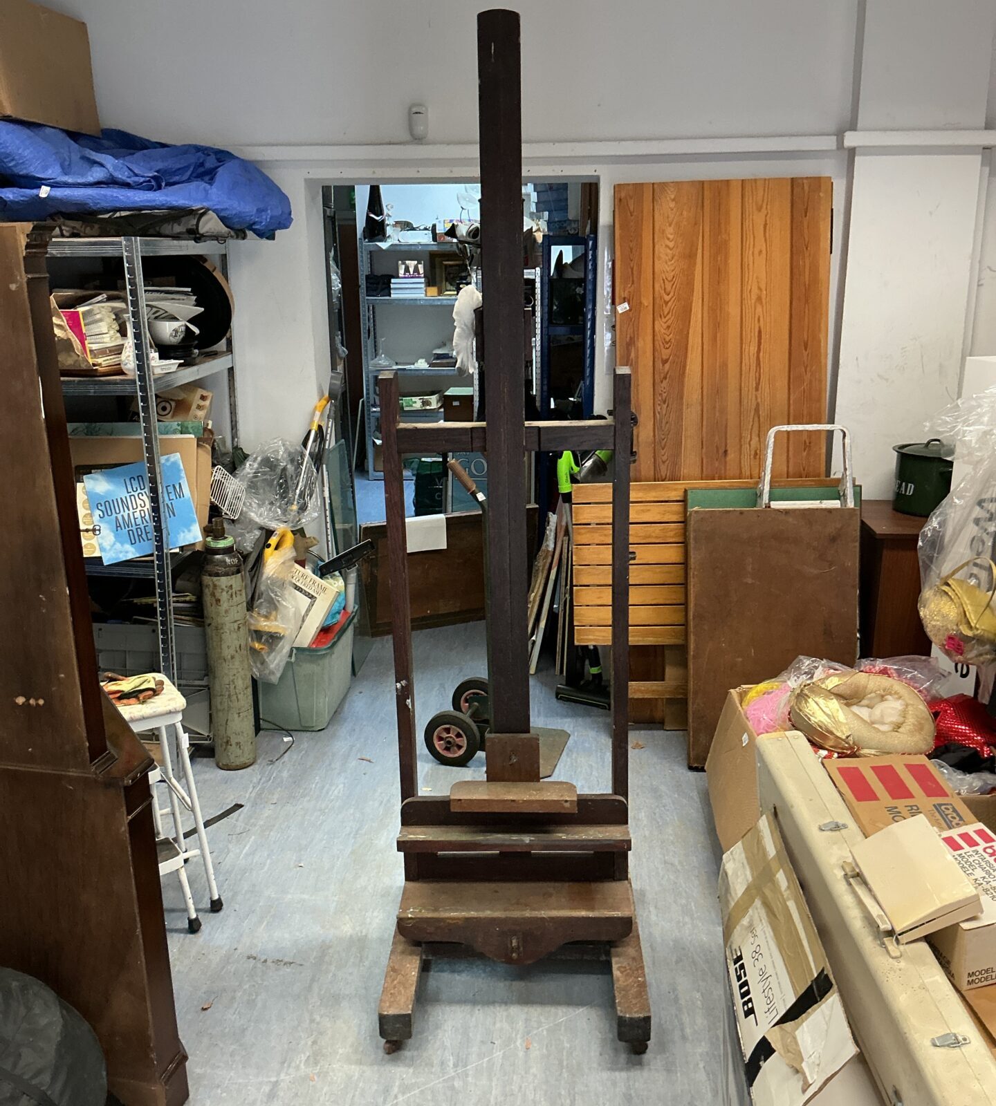 Vintage wooden artist studio easel with adjustable height.
