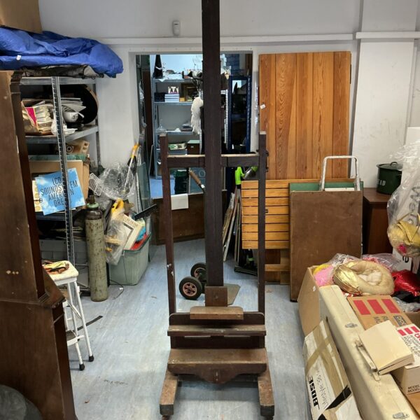 Vintage wooden artist studio easel with adjustable height.