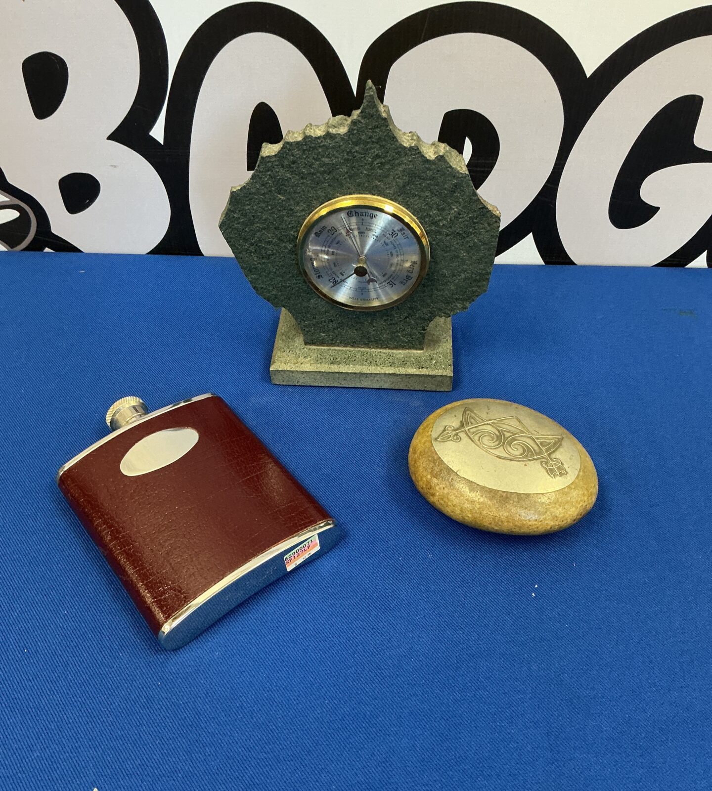 Vintage Weathermaster barometer with hip flask and polished stone.