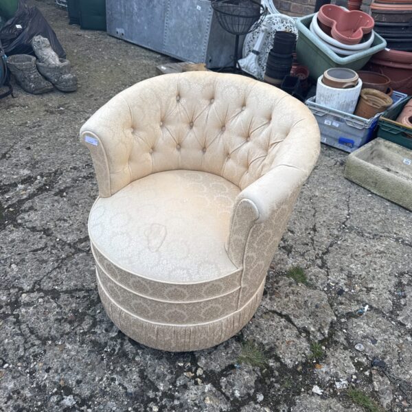 Vintage upholstered bedroom chair with button detailing.