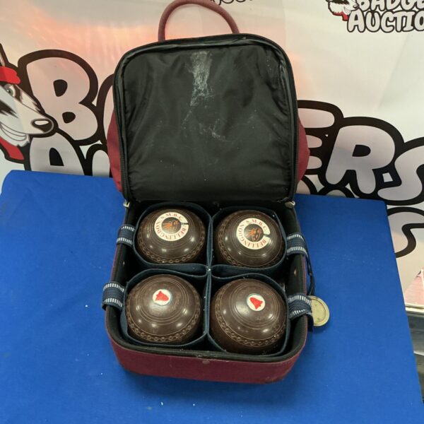 Vintage bowling balls set in navy case for lawn bowls.