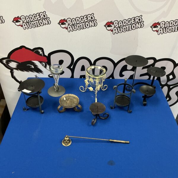 Vintage brass candle holders and snuffer for antique table decor.