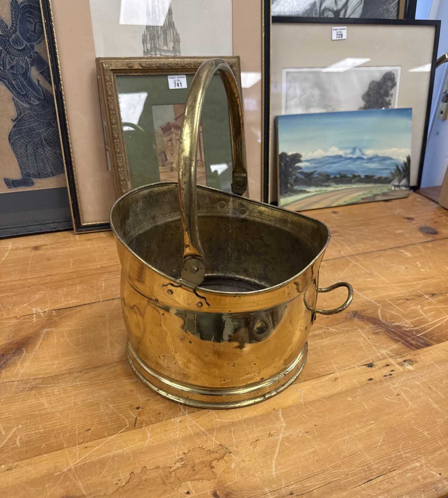 Vintage brass coal bucket with handle, antique fireplace accessory.