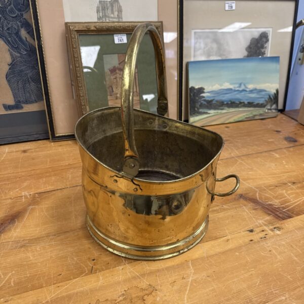 Vintage brass coal bucket with handle, antique fireplace accessory.