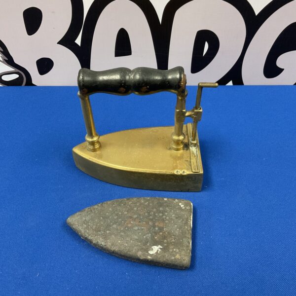 Vintage brass flat iron with wooden handle for antique pressing.