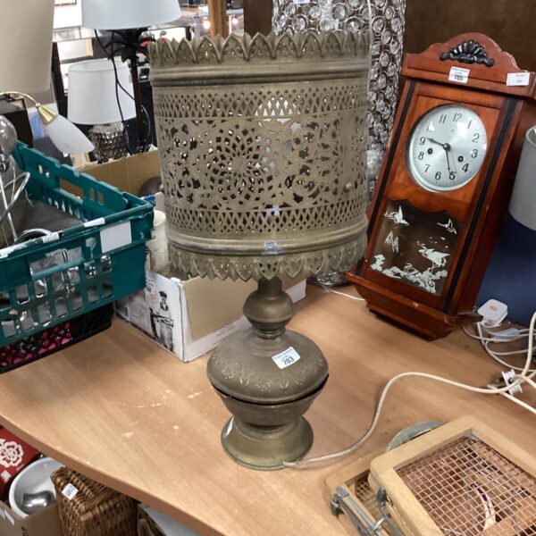 Vintage brass table lamp with intricate pierced geometric shade.