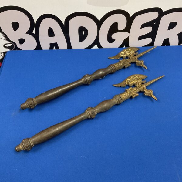 Pair of vintage brass wall axes with ornate detailing.
