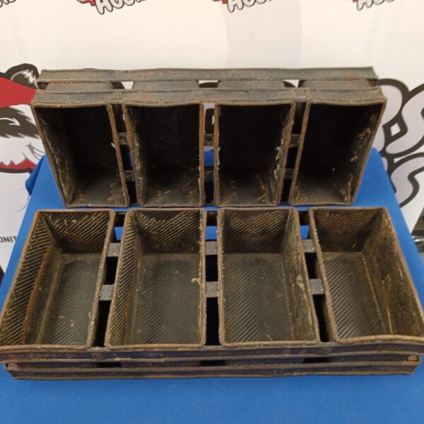 Pair of vintage metal bread baking tins with divided sections.