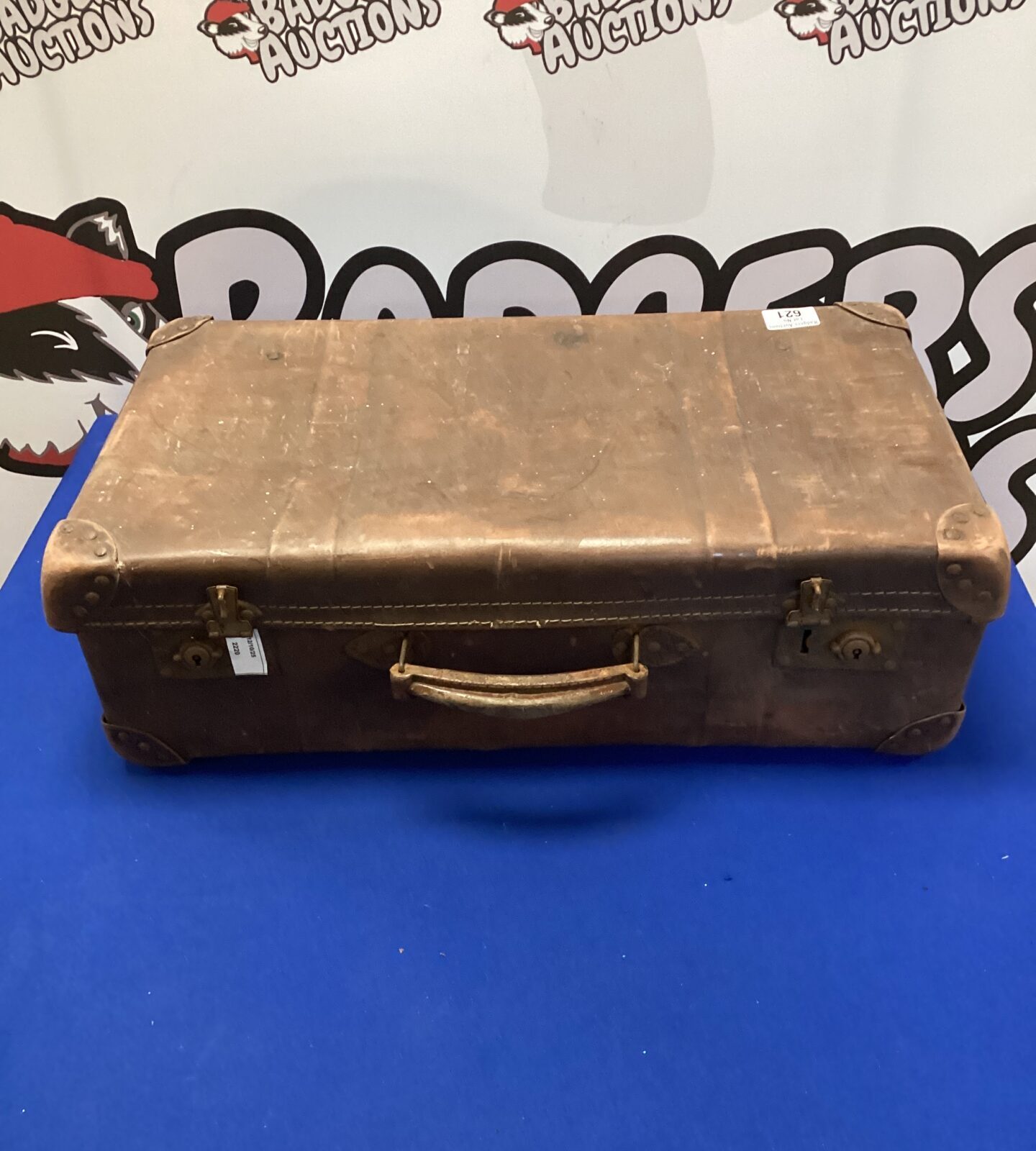 Vintage brown leather suitcase with a classic travel aesthetic.