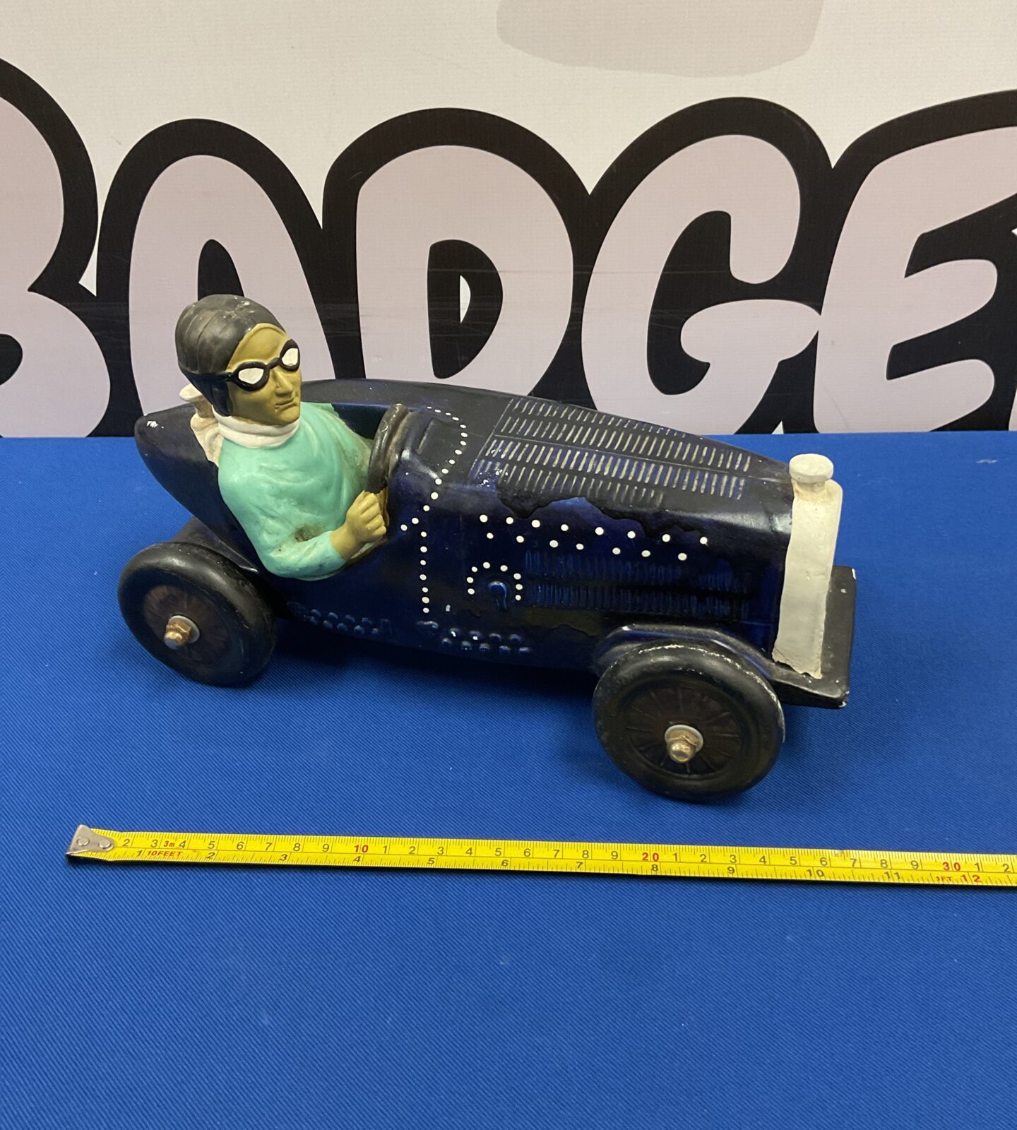 Vintage pottery Bugatti racing car ornament, classic design.