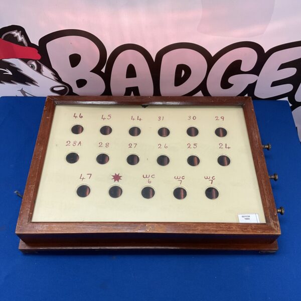 Front view of a vintage butler's bell box with numbered buttons.