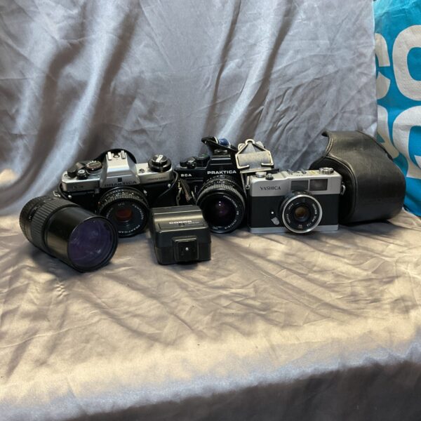 Vintage Yashica and Praktica cameras in a photography bundle.