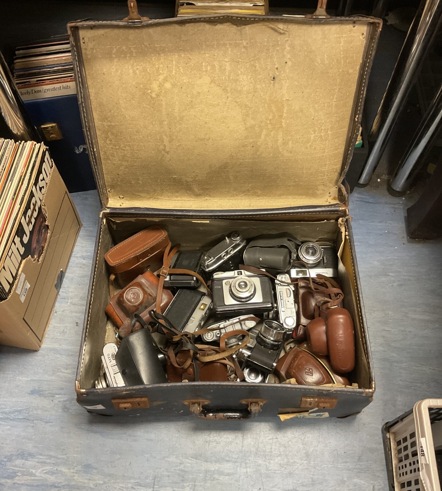 Vintage camera lot with Kodak, Voigtlander, and Zeis cameras inside a case.
