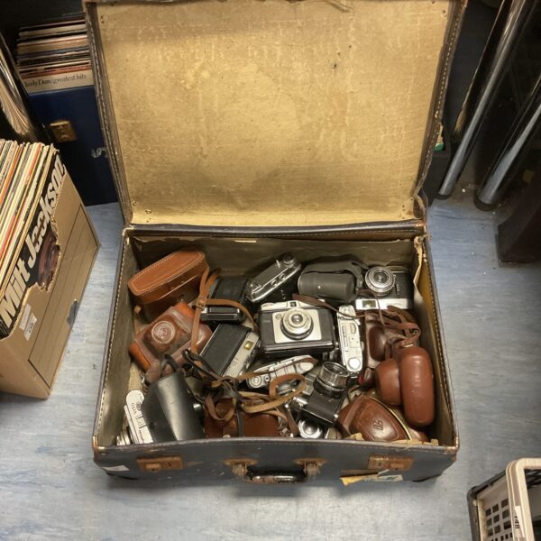 Vintage camera lot with Kodak, Voigtlander, and Zeis cameras inside a case.