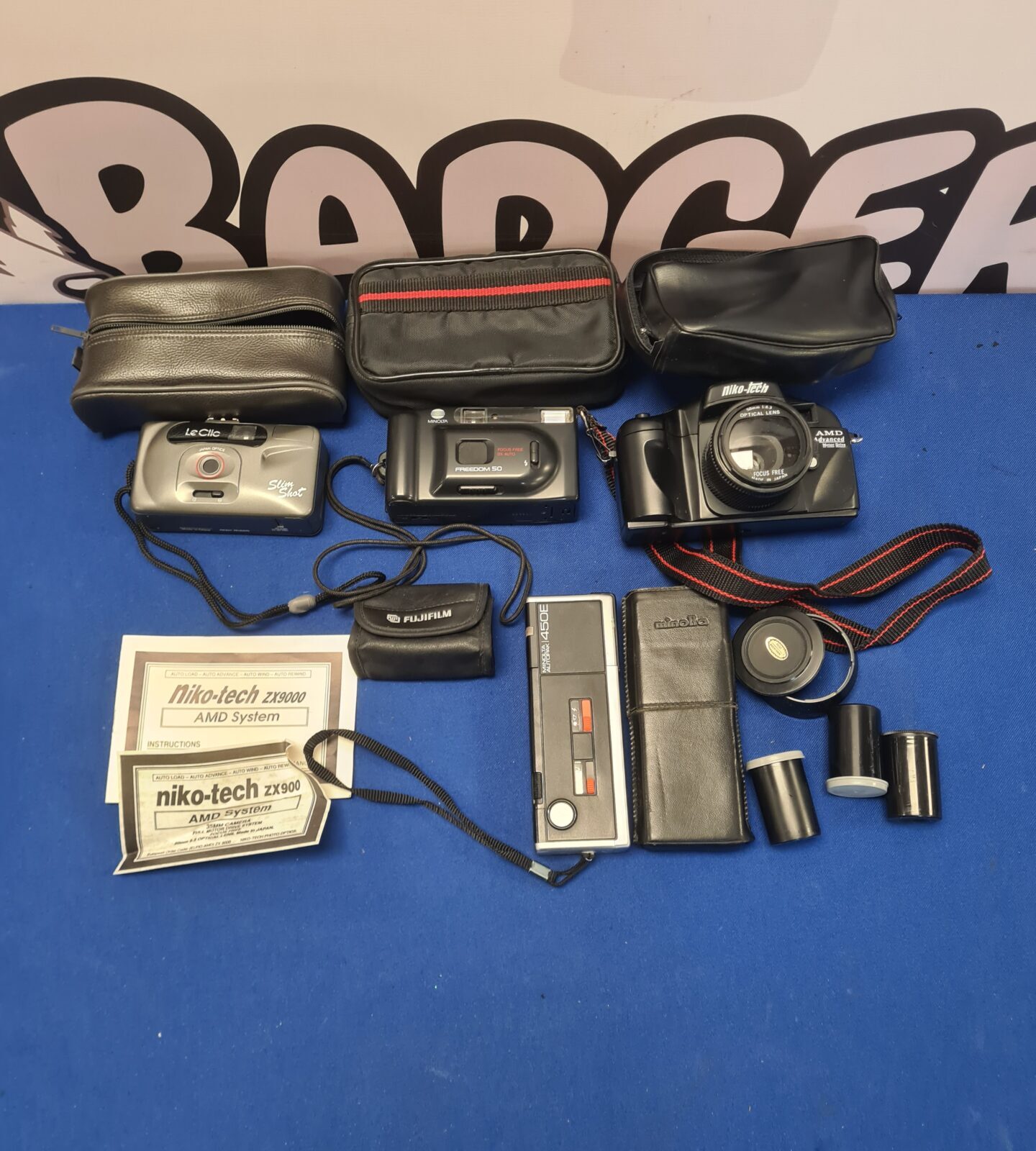 Vintage camera lot featuring a Niko Tech and Minolta film cameras.
