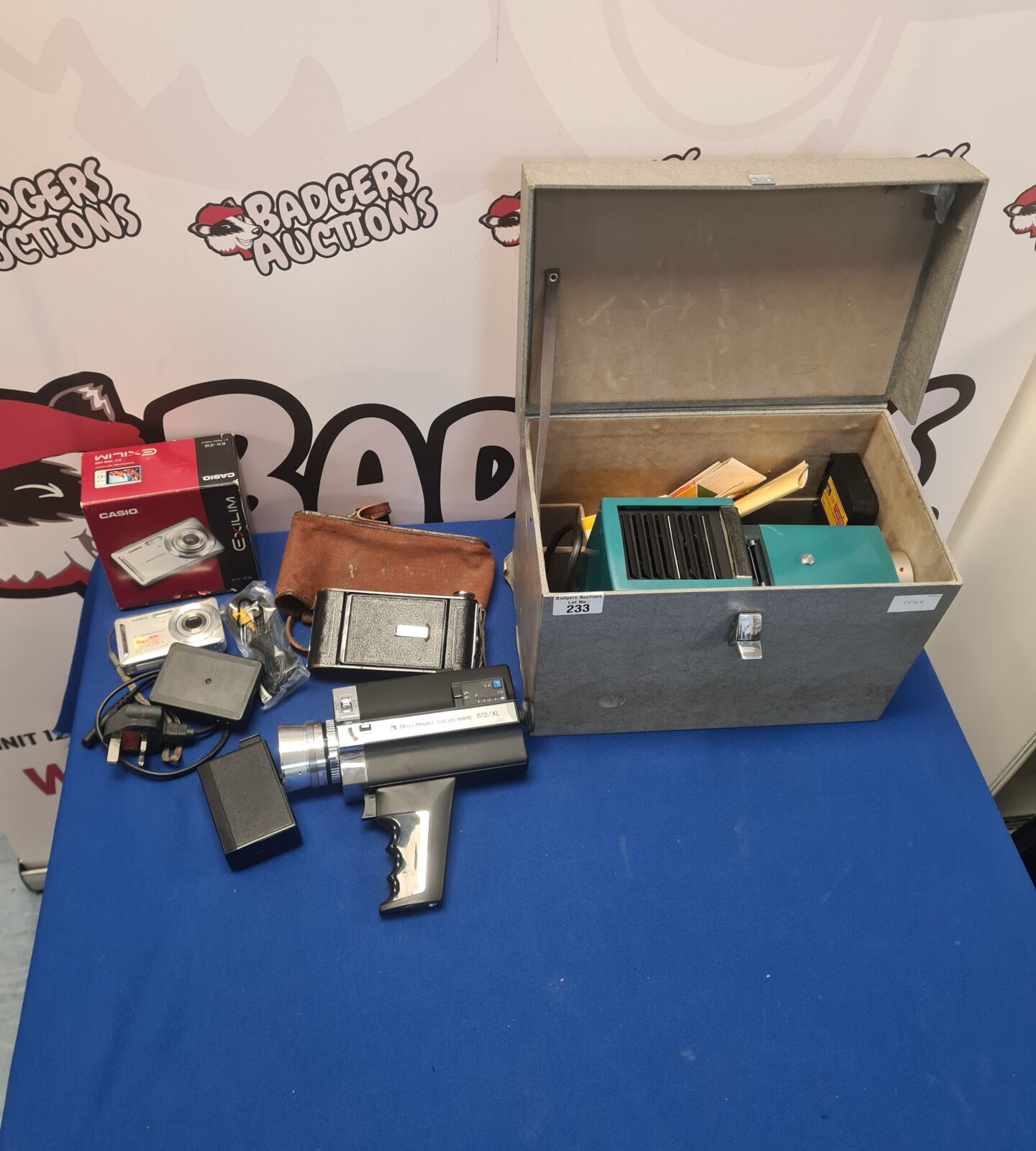 Vintage camera lot featuring Canon Exilim and Bells & Howell cameras.