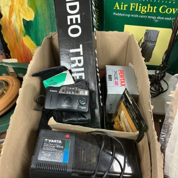 Vintage camera lot featuring a Canon camera and photography accessories.