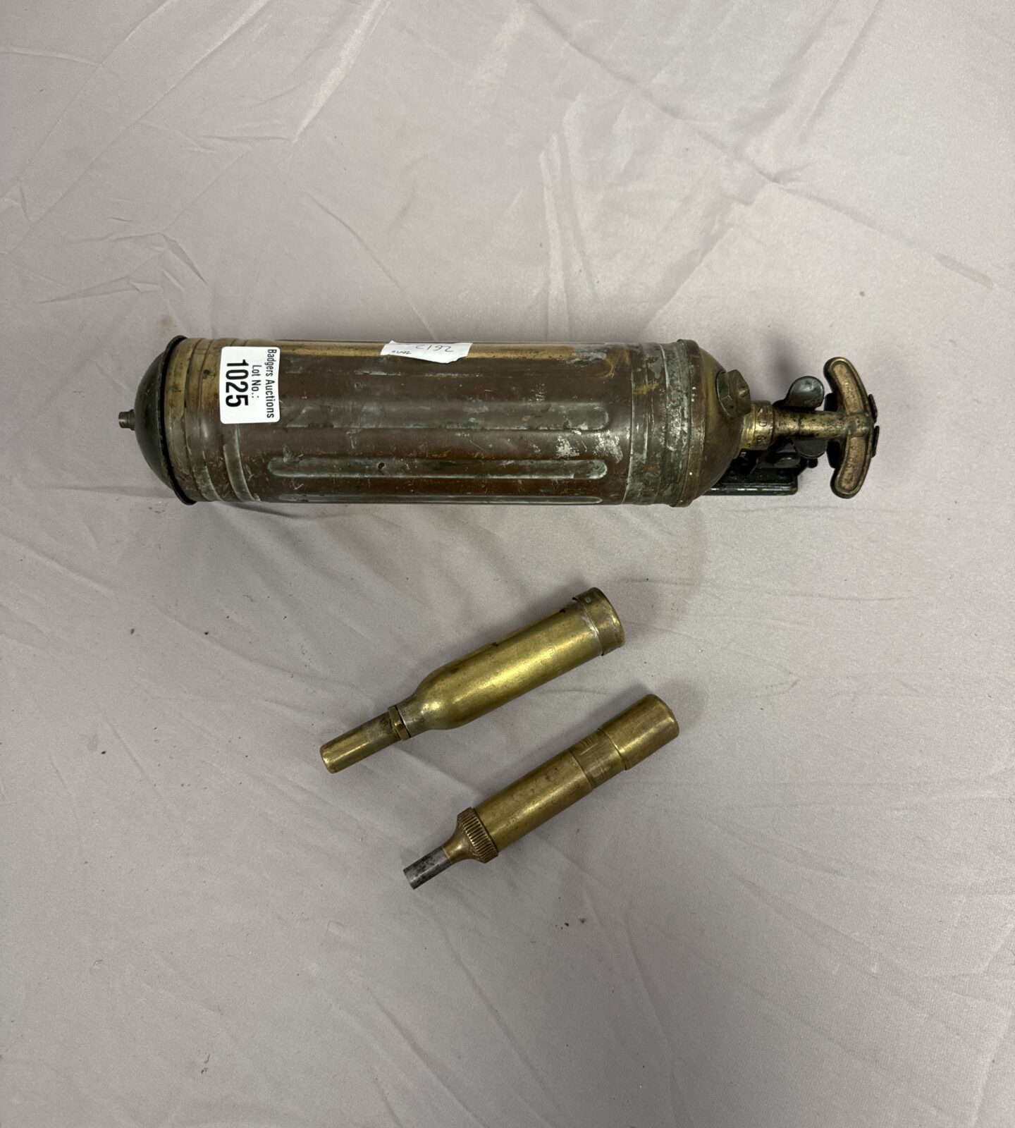 Vintage car fire extinguisher and motorcycle grease guns, automotive collectibles.