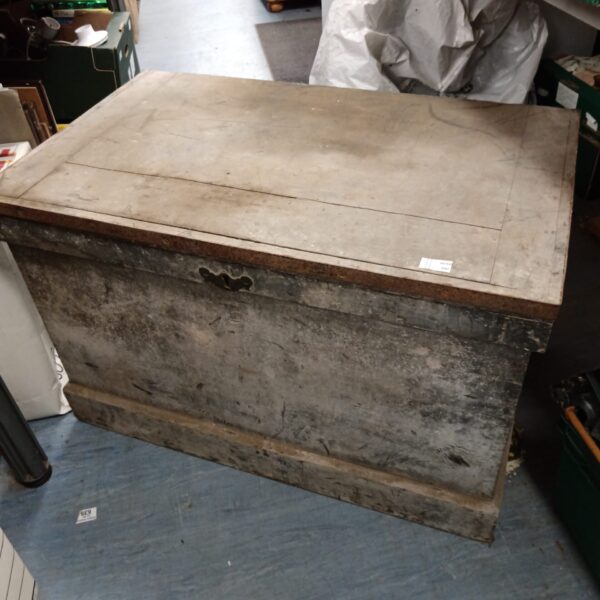 Front view of a large vintage carpenter's tool chest with weathered wood.