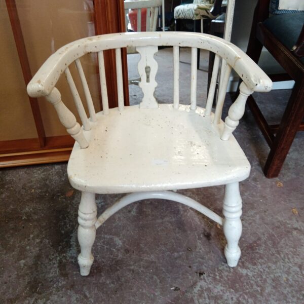 Vintage child's chair with a painted stick back design.