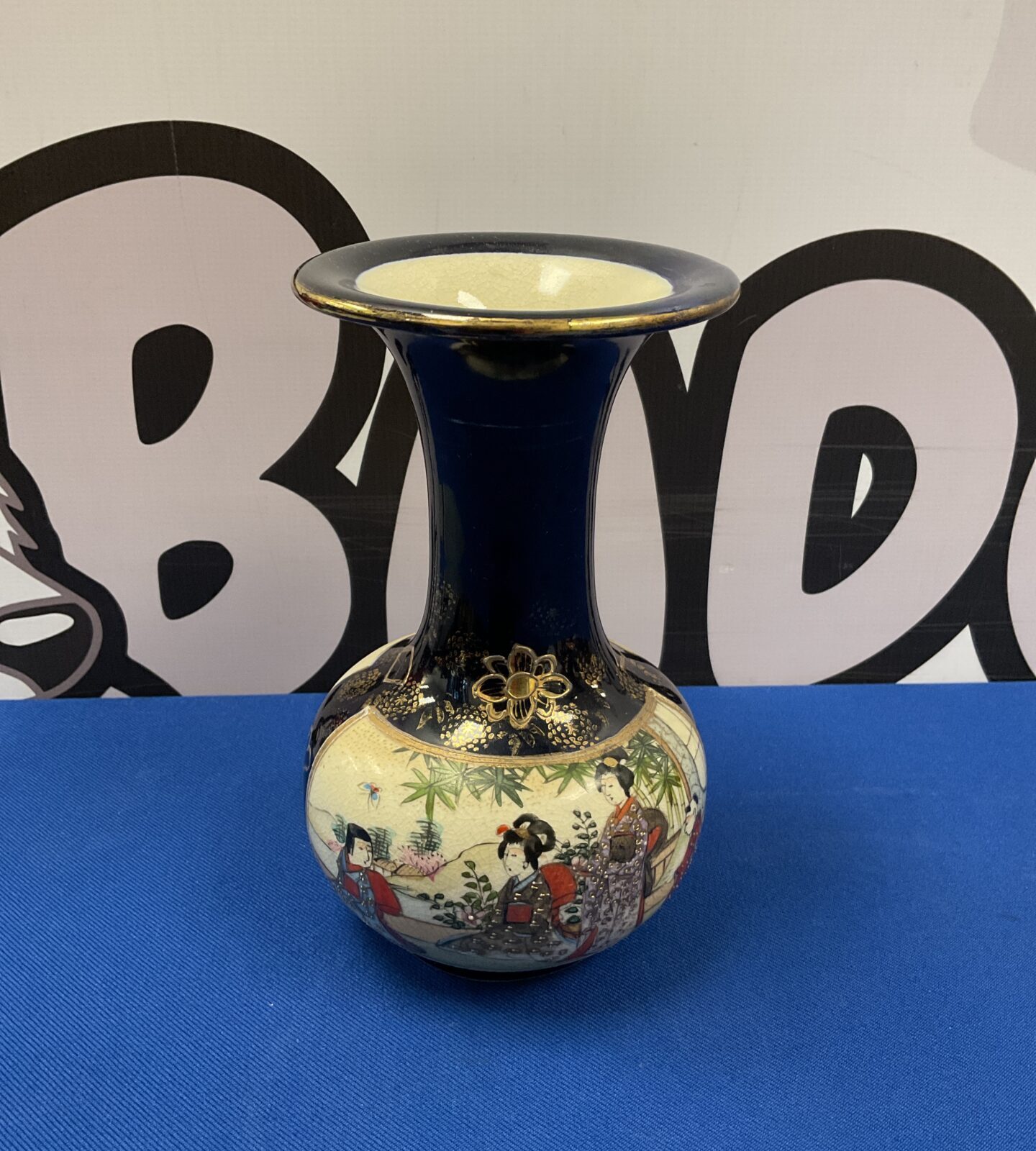 Vintage Chinese vase with black glaze and hand-painted figures.