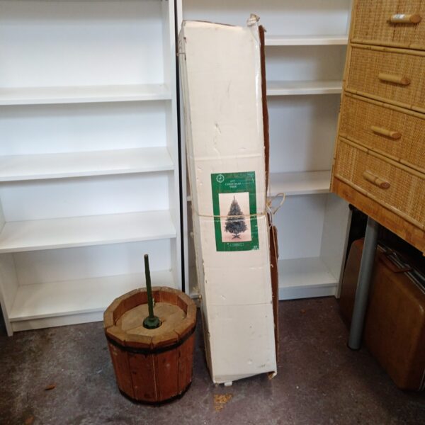 Vintage 6ft Christmas tree with rustic wooden barrel stand for holiday decor.