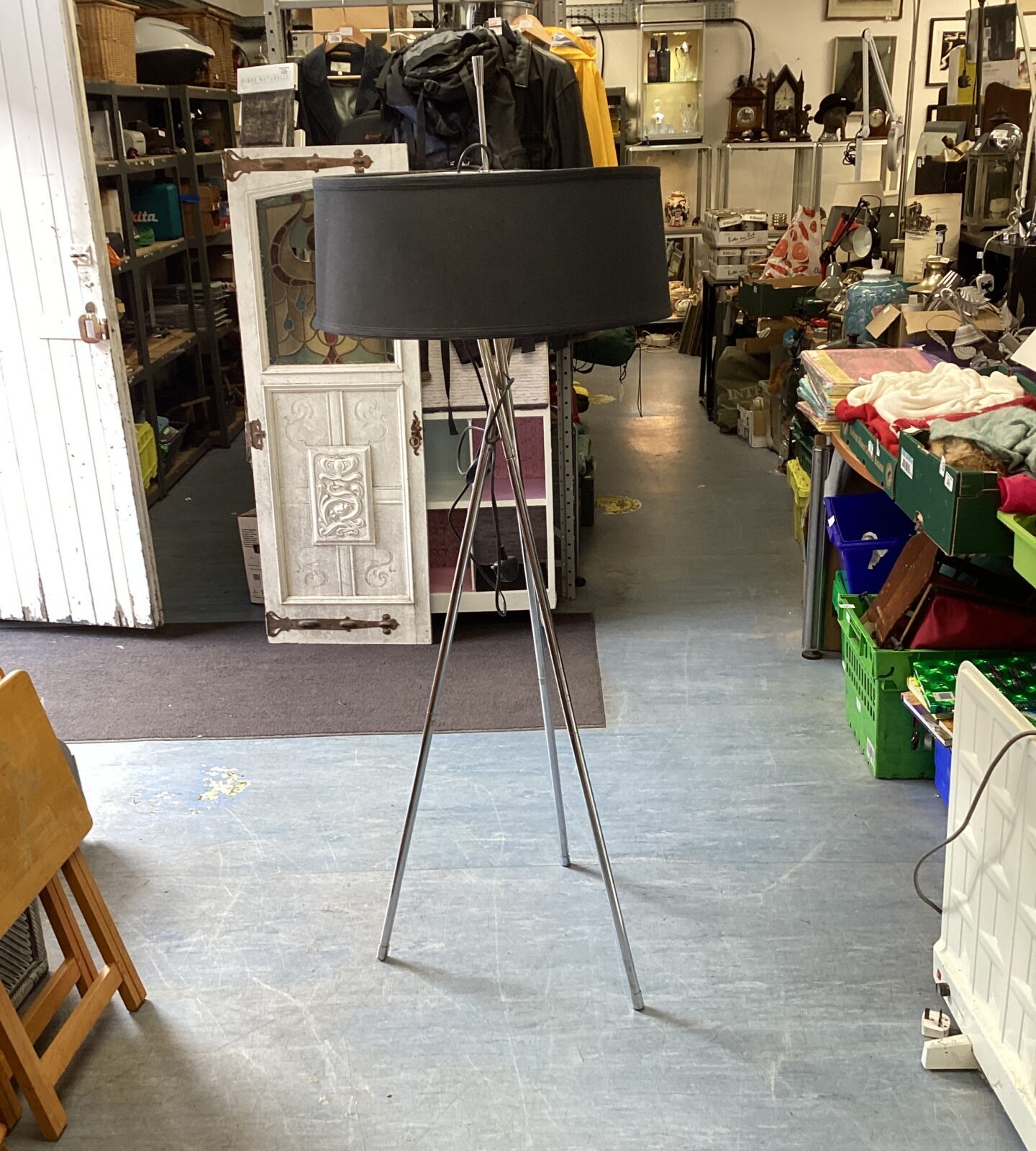Vintage chrome floor lamp with adjustable head and tripod base.