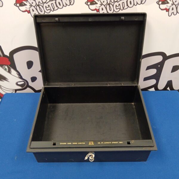 Open vintage Chubb lock box with black velvet lining.