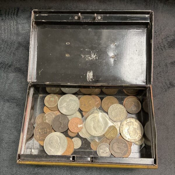 Vintage coin tin filled with assorted old coins for collectors.