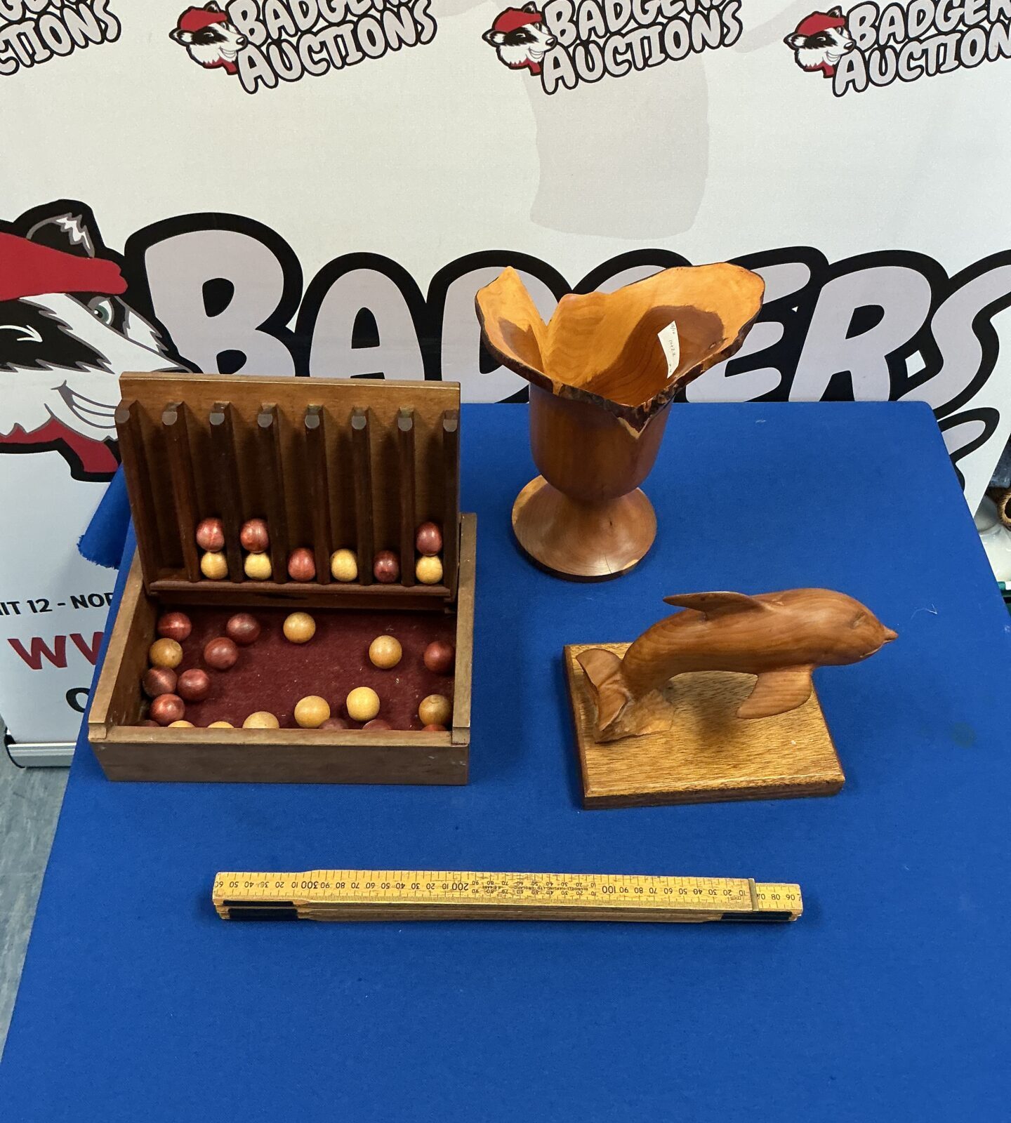 Vintage wooden Connect Four game with carved dolphin detail.