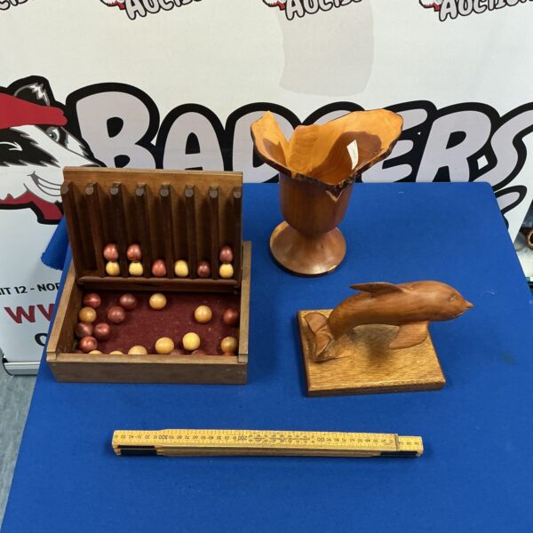 Vintage wooden Connect Four game with carved dolphin detail.