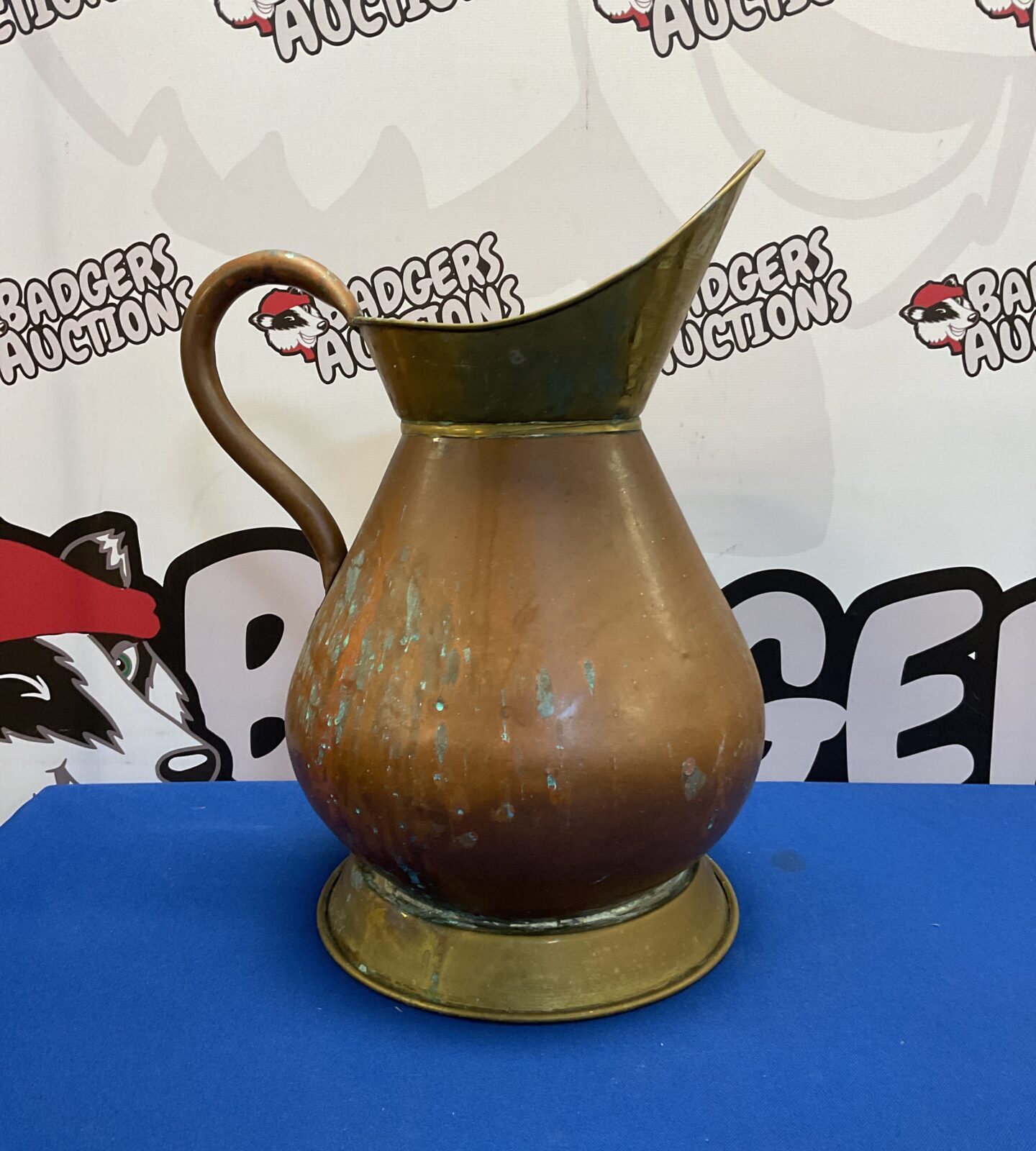 Large vintage copper haystack pitcher with brass accents.
