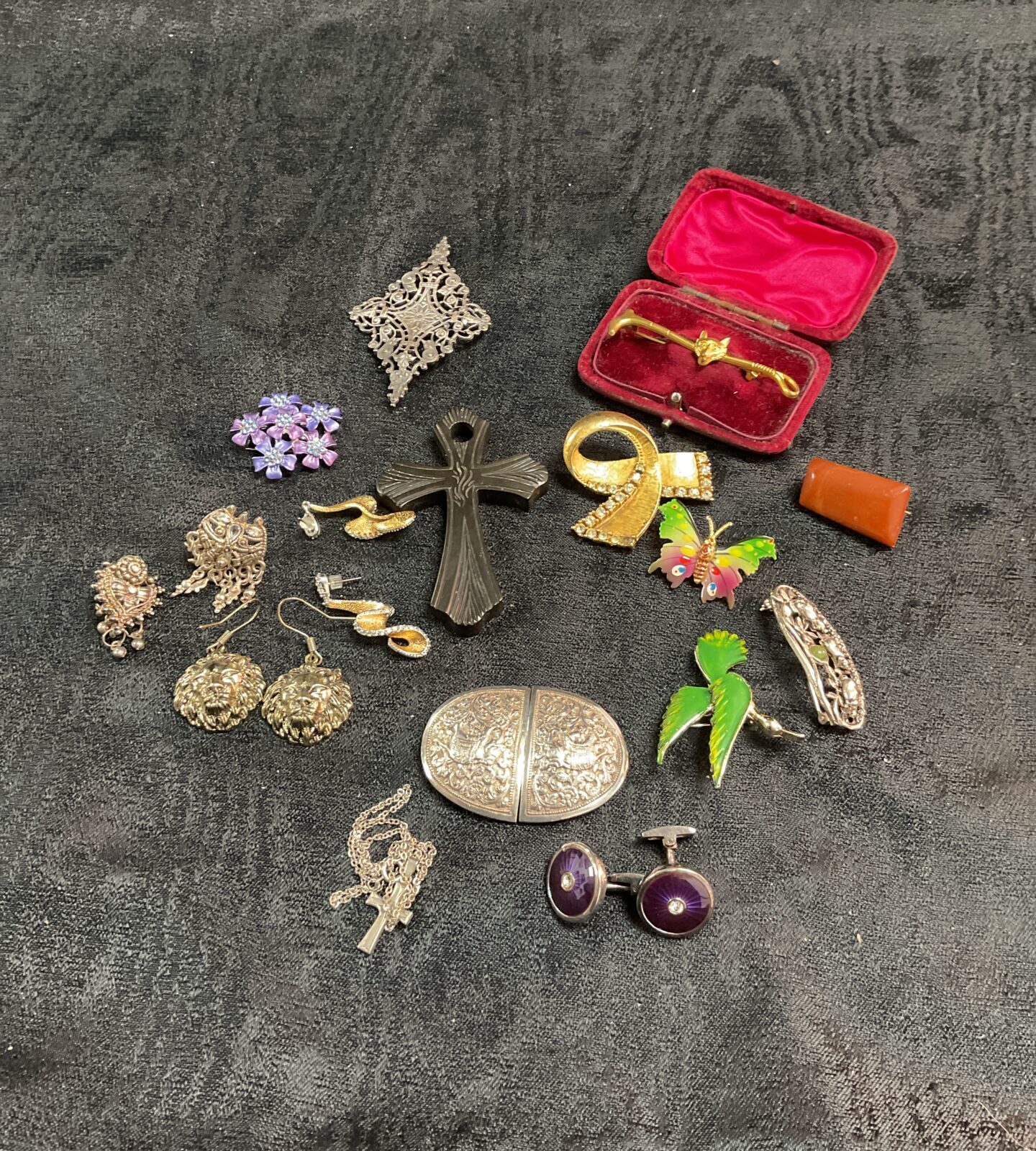 Vintage costume jewellery collection featuring brooches and a belt buckle.