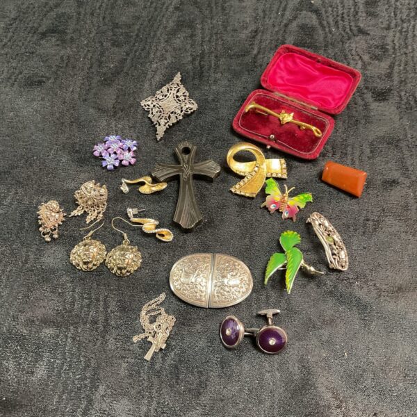 Vintage costume jewellery collection featuring brooches and a belt buckle.